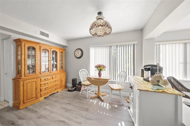 dining area featuring light wood-type flooring