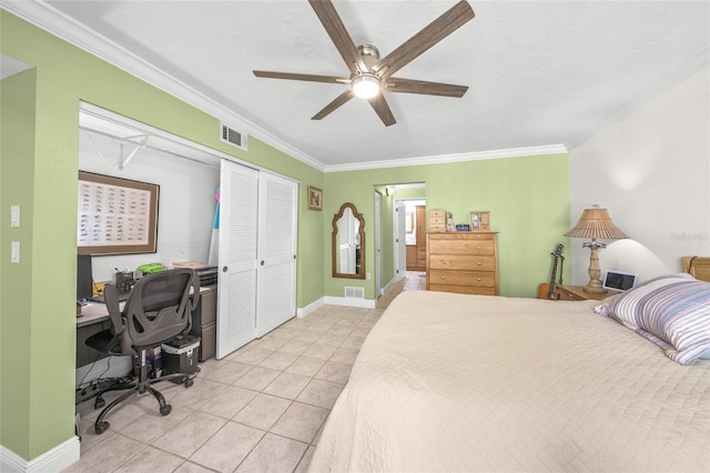 tiled bedroom with a closet, track lighting, ceiling fan, and crown molding