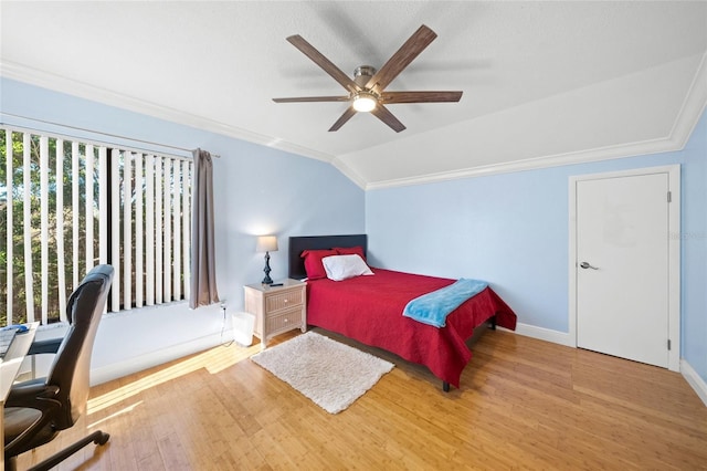 bedroom featuring multiple windows, hardwood / wood-style floors, ceiling fan, and lofted ceiling