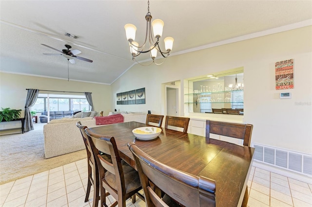 dining area with ceiling fan with notable chandelier, light colored carpet, lofted ceiling, and ornamental molding