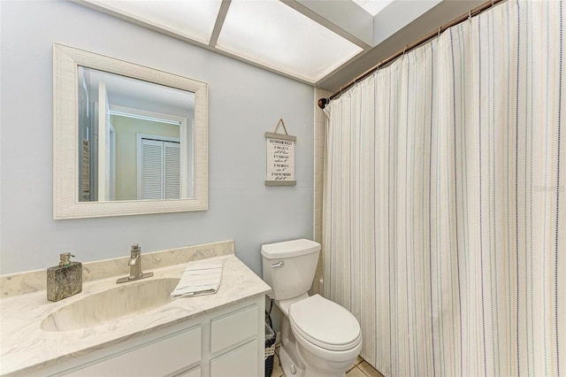 bathroom featuring vanity, toilet, and walk in shower