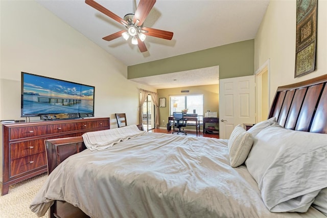 carpeted bedroom featuring vaulted ceiling and ceiling fan