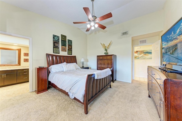 bedroom with light colored carpet, ensuite bath, ceiling fan, and lofted ceiling