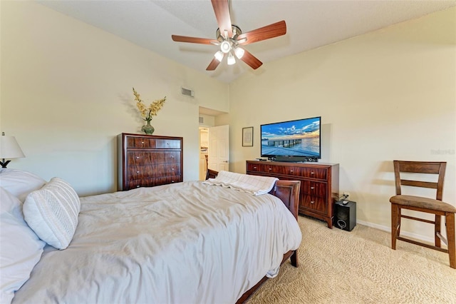 carpeted bedroom with ceiling fan and vaulted ceiling