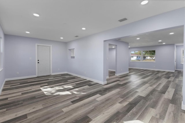 empty room with recessed lighting, visible vents, and baseboards