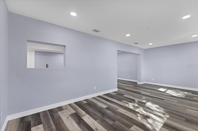 empty room featuring dark wood-type flooring