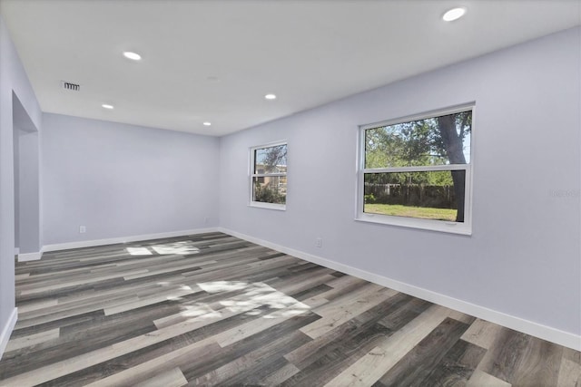 unfurnished room with recessed lighting, visible vents, and baseboards