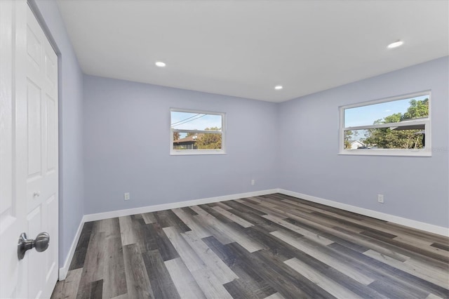 unfurnished bedroom with recessed lighting, baseboards, and dark wood-style flooring