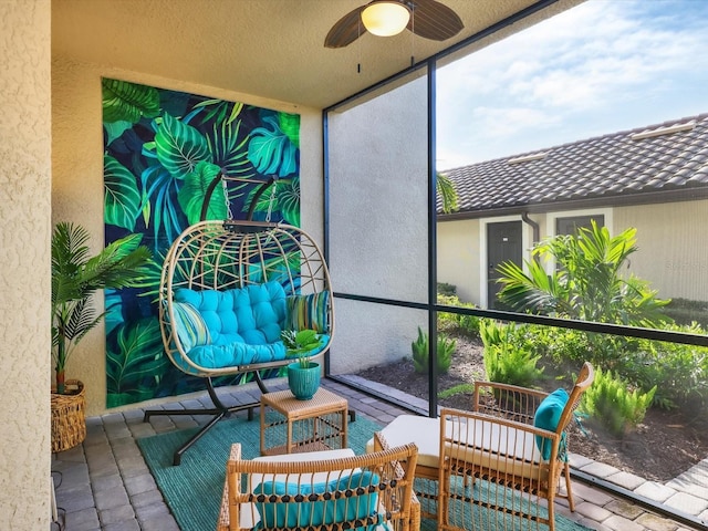 sunroom featuring ceiling fan