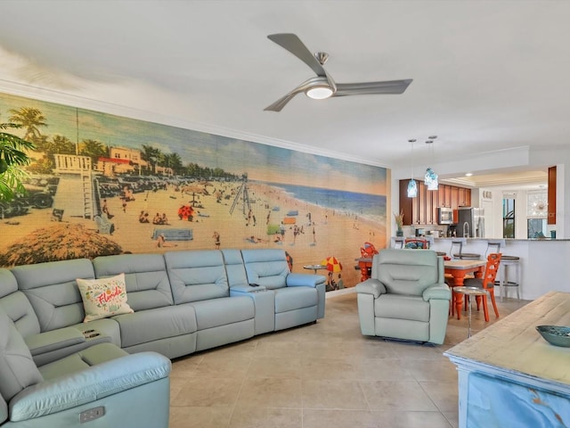 living room with crown molding, light tile patterned flooring, and ceiling fan