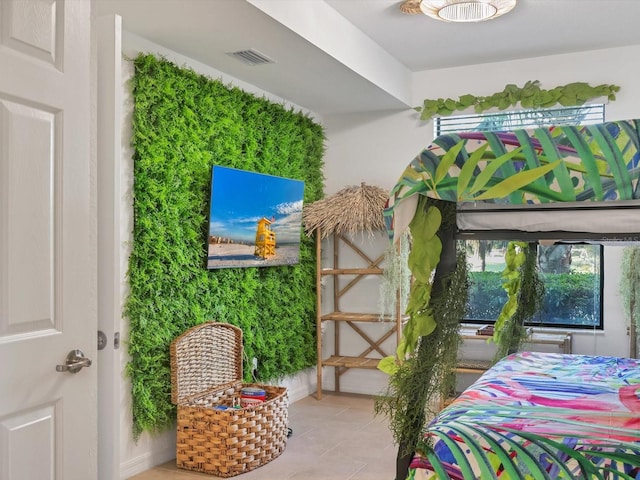 bedroom with light tile patterned floors