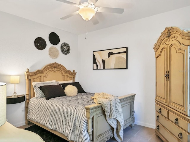 tiled bedroom featuring ceiling fan