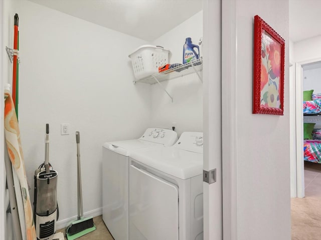 laundry area with light tile patterned floors and independent washer and dryer