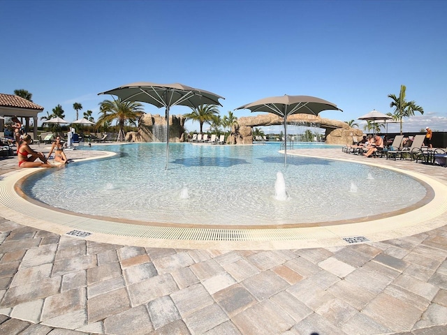 view of pool featuring pool water feature and a patio area