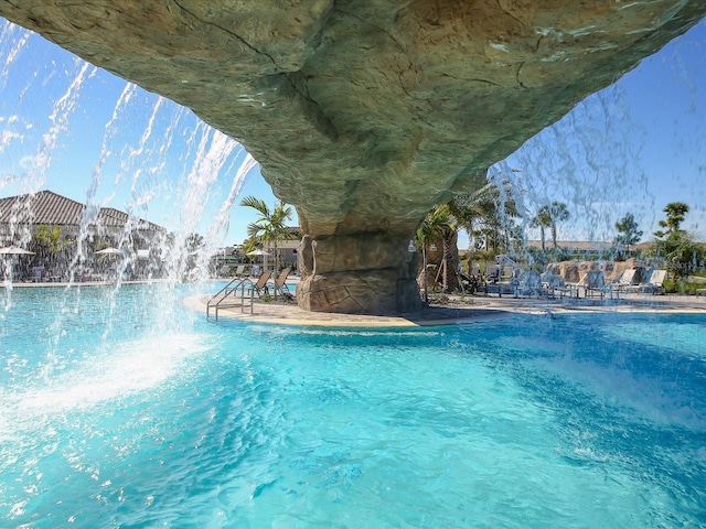 view of pool with pool water feature