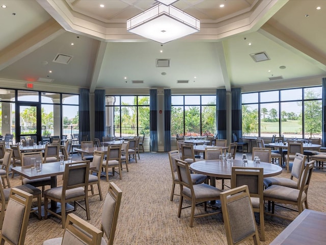 carpeted dining area featuring beamed ceiling, a towering ceiling, and a wealth of natural light