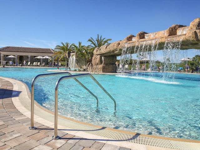 view of swimming pool featuring pool water feature