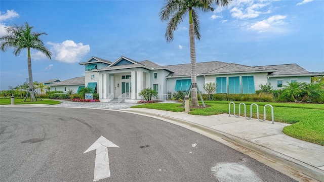 10142 Crystal Isles Cir, Sarasota, FL 34241 - greek revival house with a front yard and stucco siding
