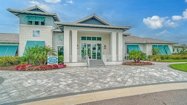 doorway to property with covered porch and french doors