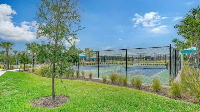 view of sport court with a yard