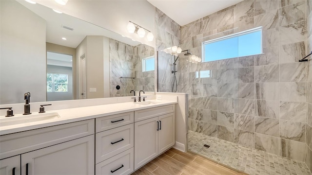 10142 Crystal Isles Cir, Sarasota, FL 34241 - full bathroom with double vanity, a walk in shower, and wood tiled floors