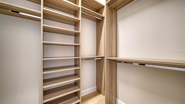 walk in closet featuring light hardwood / wood-style flooring