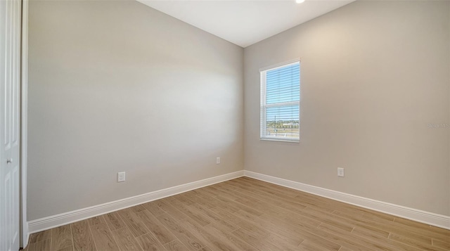 unfurnished room with light wood-type flooring