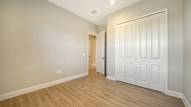 10142 Crystal Isles Cir, Sarasota, FL 34241 - unfurnished bedroom featuring light wood-style flooring and a closet
