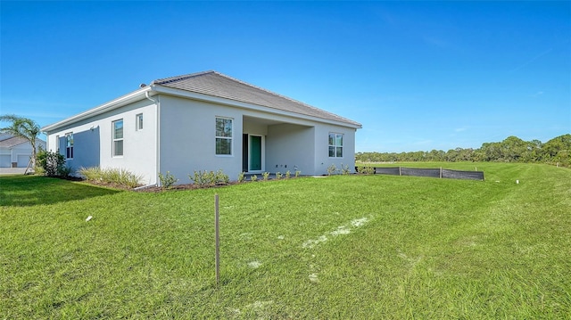 10142 Crystal Isles Cir, Sarasota, FL 34241 - rear view of property featuring stucco siding and a lawn