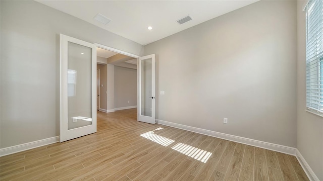10142 Crystal Isles Cir, Sarasota, FL 34241 - spare room with french doors, light wood-style floors, and recessed lighting