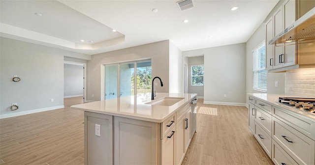 10142 Crystal Isles Cir, Sarasota, FL 34241 - kitchen featuring under cabinet range hood, light countertops, appliances with stainless steel finishes, recessed lighting, and light wood-style flooring