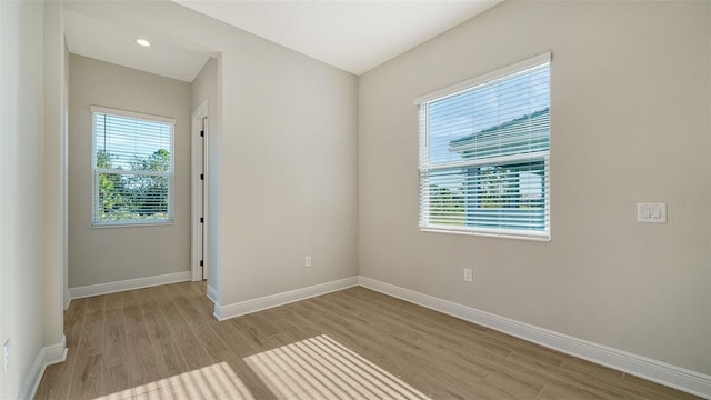 unfurnished room with light hardwood / wood-style flooring