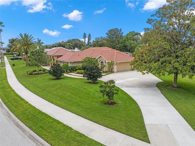 mediterranean / spanish house featuring a front yard and a garage