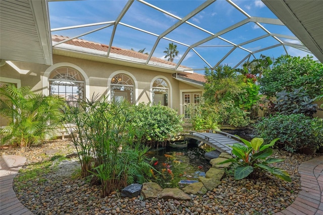 view of patio with glass enclosure