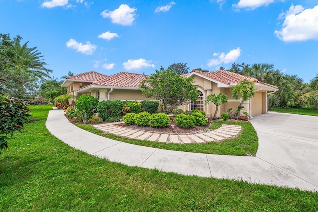 mediterranean / spanish-style house featuring a garage and a front lawn