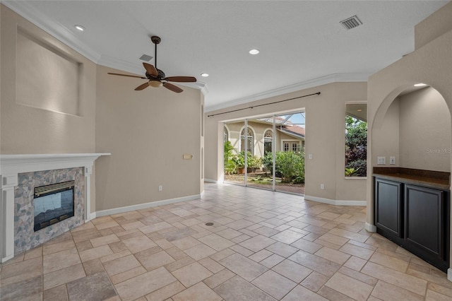 unfurnished living room with ceiling fan and ornamental molding