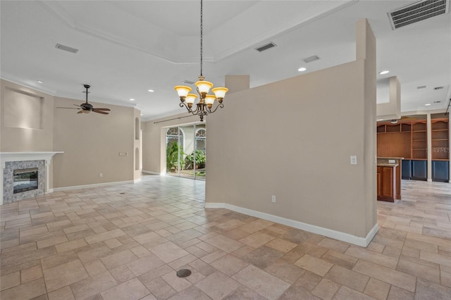 unfurnished living room featuring a high end fireplace, ceiling fan with notable chandelier, and ornamental molding