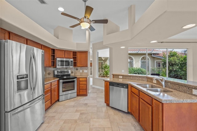 kitchen with light stone countertops, sink, stainless steel appliances, backsplash, and crown molding