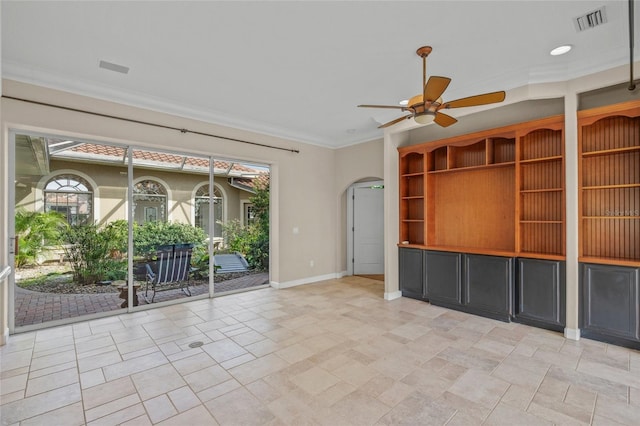 unfurnished room with ceiling fan and ornamental molding