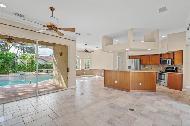 kitchen featuring decorative backsplash, a kitchen island, and stainless steel appliances