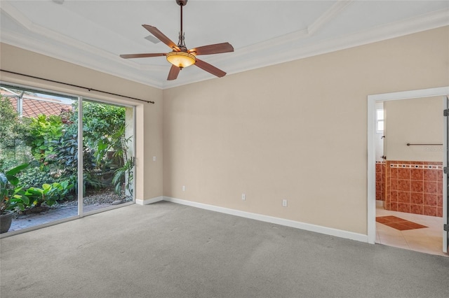 empty room featuring ceiling fan, light colored carpet, and ornamental molding