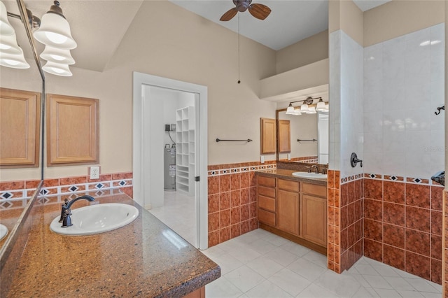 bathroom featuring vanity, electric water heater, tile patterned flooring, and ceiling fan