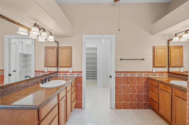 bathroom featuring vanity, tile patterned floors, and tile walls