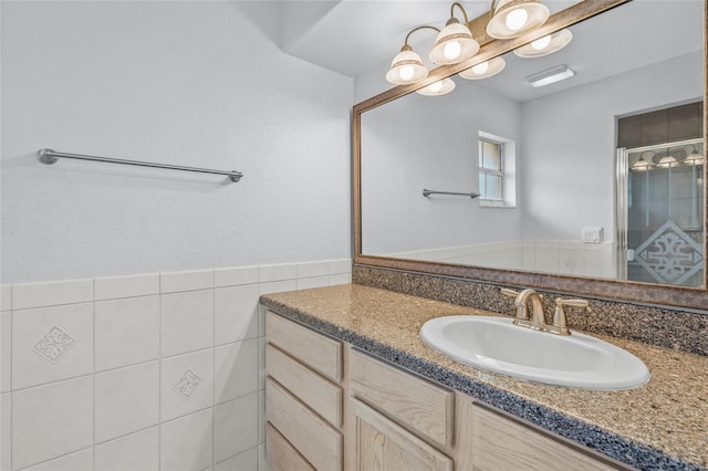 bathroom with vanity and tile walls