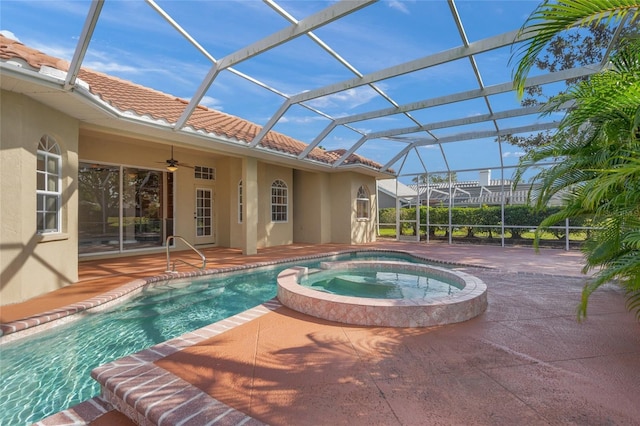 view of pool featuring an in ground hot tub, glass enclosure, ceiling fan, and a patio area