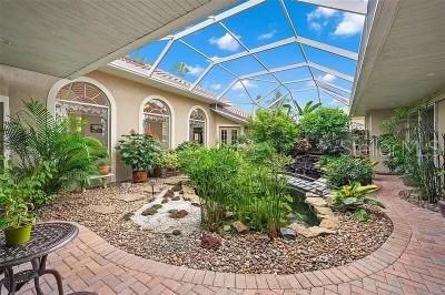 view of patio featuring glass enclosure