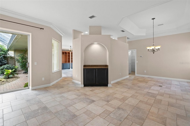 unfurnished living room featuring ornamental molding and a chandelier