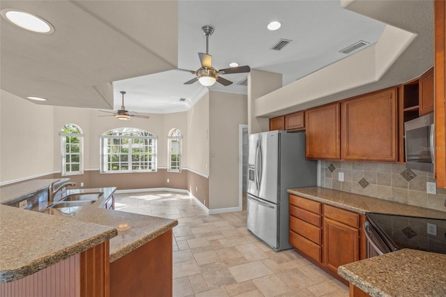 kitchen with appliances with stainless steel finishes, tasteful backsplash, ceiling fan, crown molding, and sink