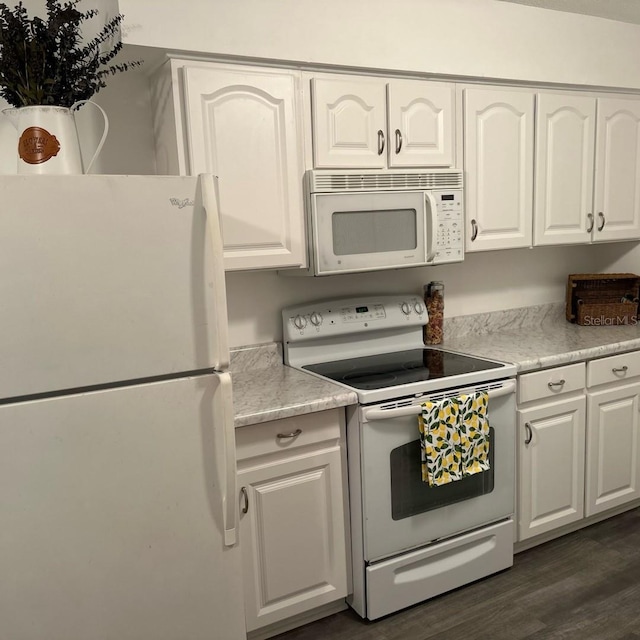 kitchen with white cabinets, white appliances, and dark wood-type flooring