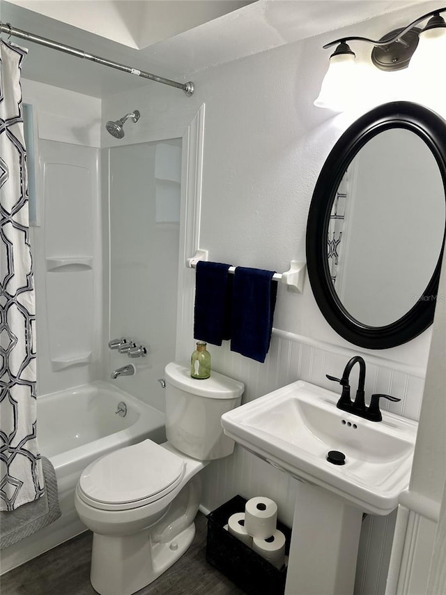 bathroom with shower / bathtub combination with curtain, wood-type flooring, and toilet